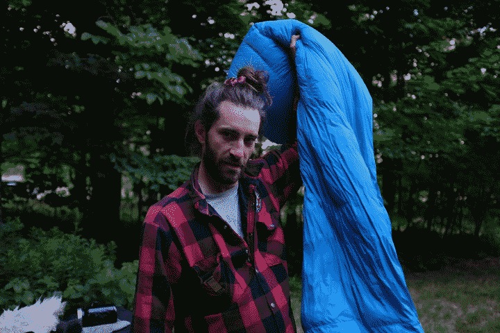 Russ holding his sleeping bag in the last morning's light