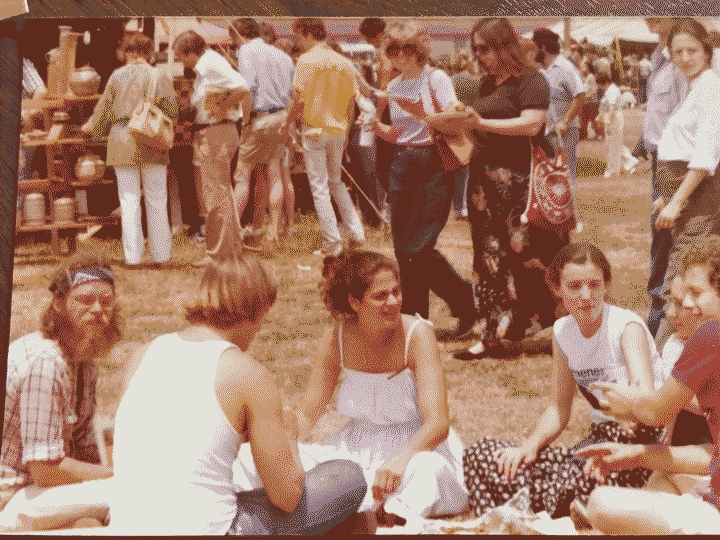 My mom among her hippie friends having a picnic